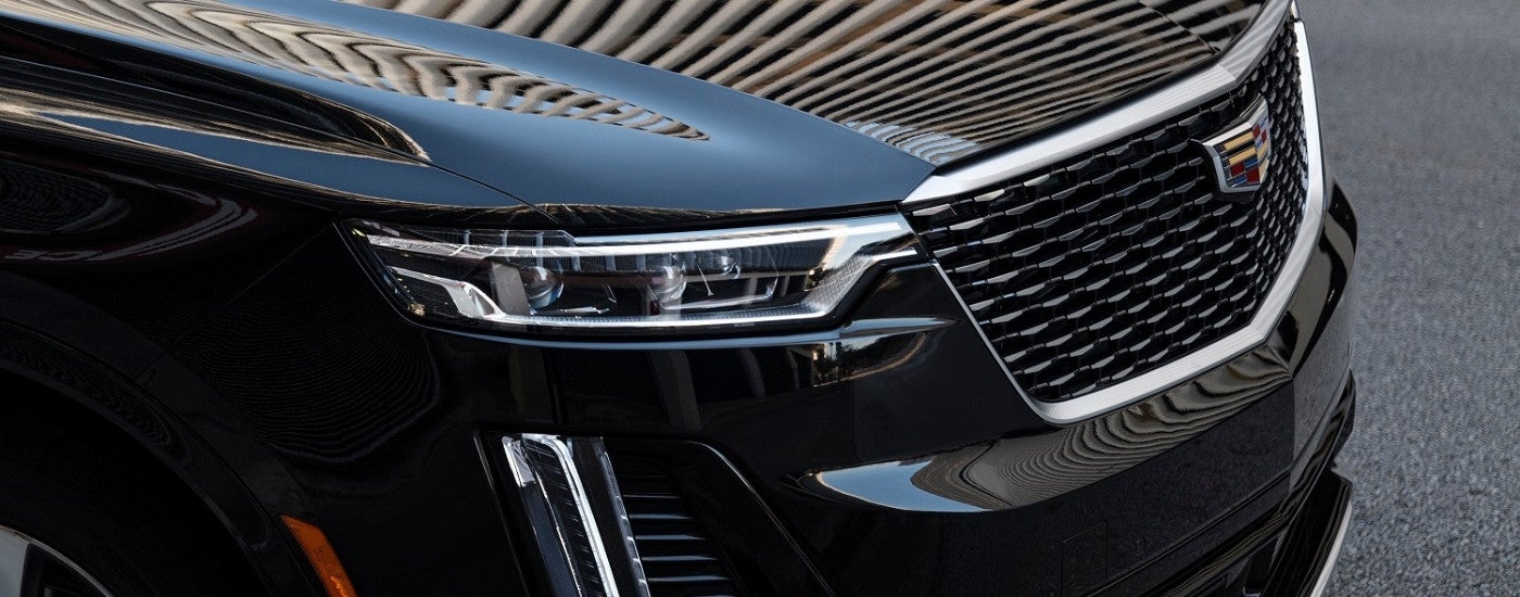 A close-up of the front of a black 2025 Cadillac XT6.