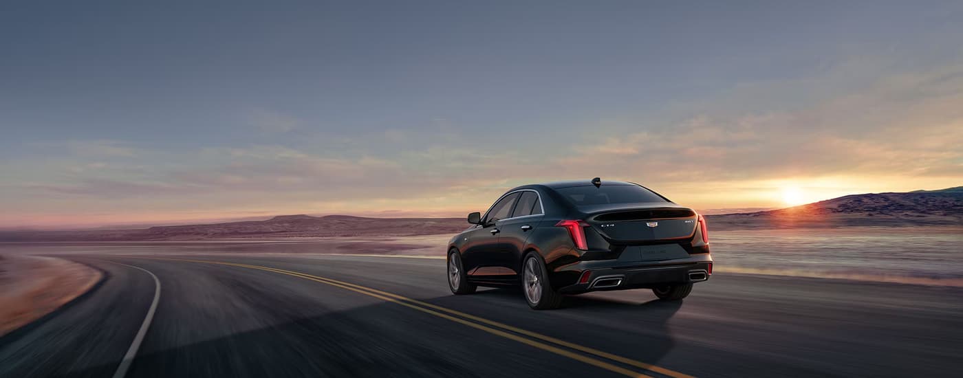 Black 2026 Cadillac CT4 driving on an open highway