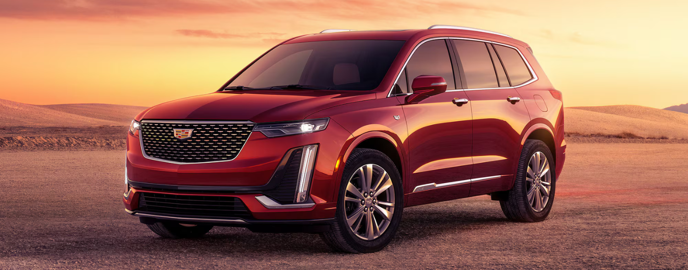 Red 2026 Cadillac XT6 parked at an angle in a desert