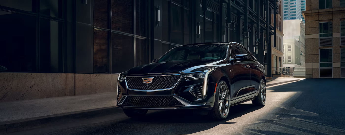 Black 2025 Cadillac CT4 for sale parked in an alleyway.