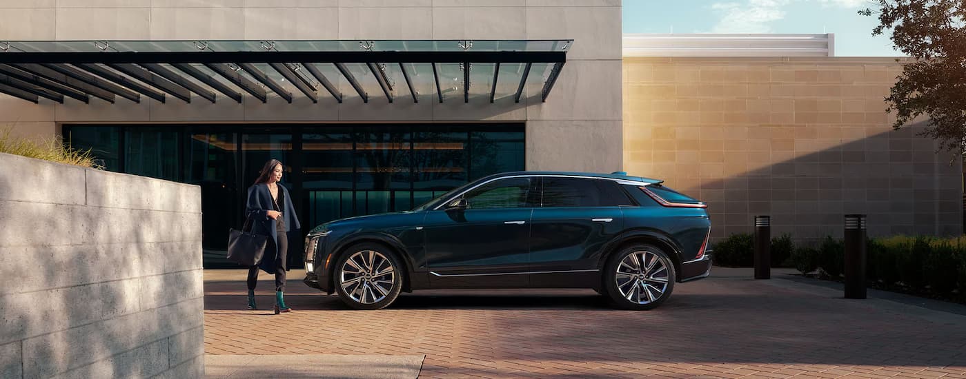A side view of a blue 2025 Cadillac LYRIQ parked at a Cadillac dealer near Chesterfield Township.
