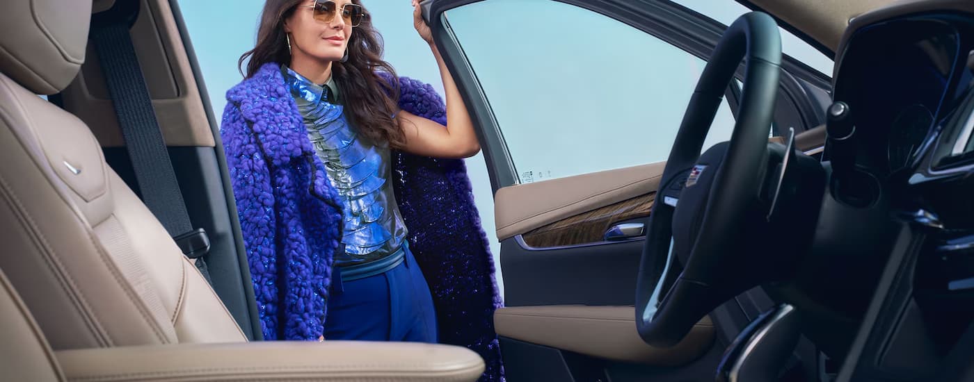 Woman opening the door of a 2025 Cadillac XT6