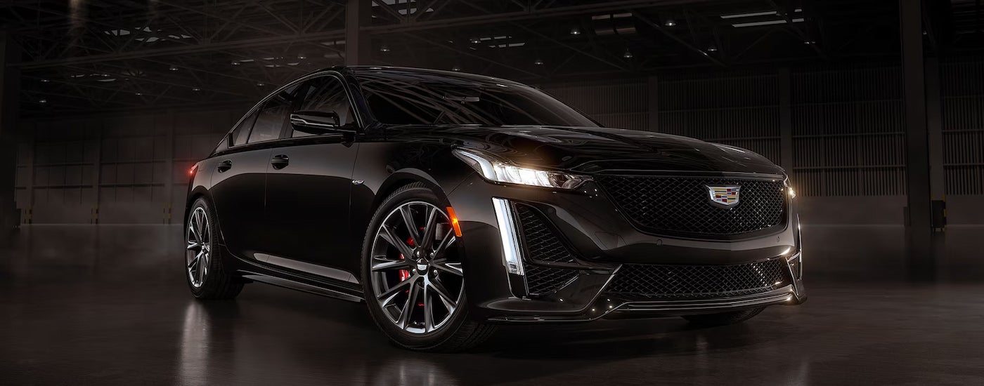 A black 2024 Cadillac CT5-V parked in a dark garage.
