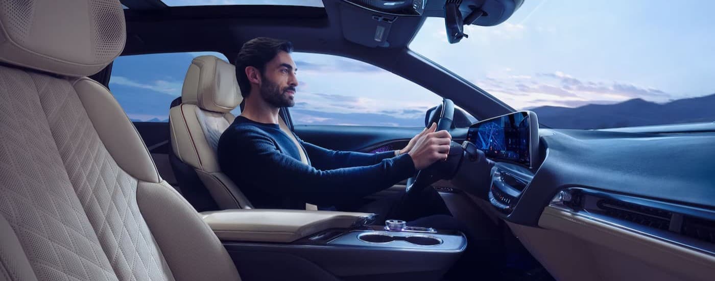 A person driving in a 2026 Cadillac LYRIQ.