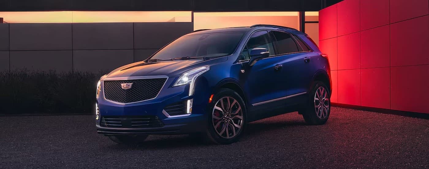 A blue 2025 Cadillac XT5 parked on a driveway.
