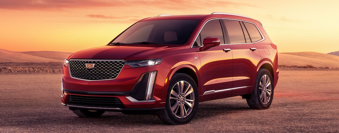 Red 2026 Cadillac XT6 for sale near Troy parked off-road.