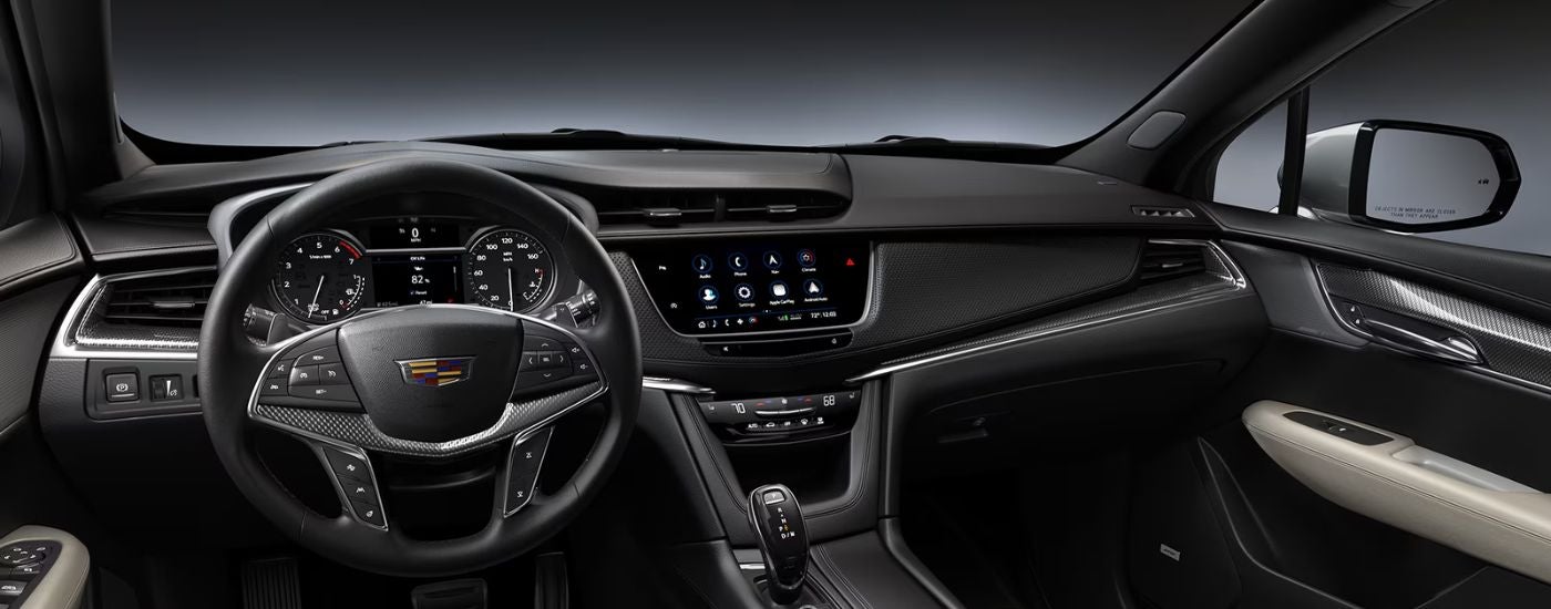 Black interior of a 2026 Cadillac XT5 infotainment and steering.