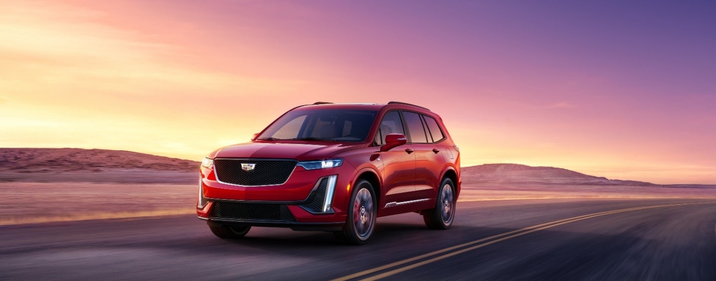 A red 2025 Cadillac XT6 from the front.