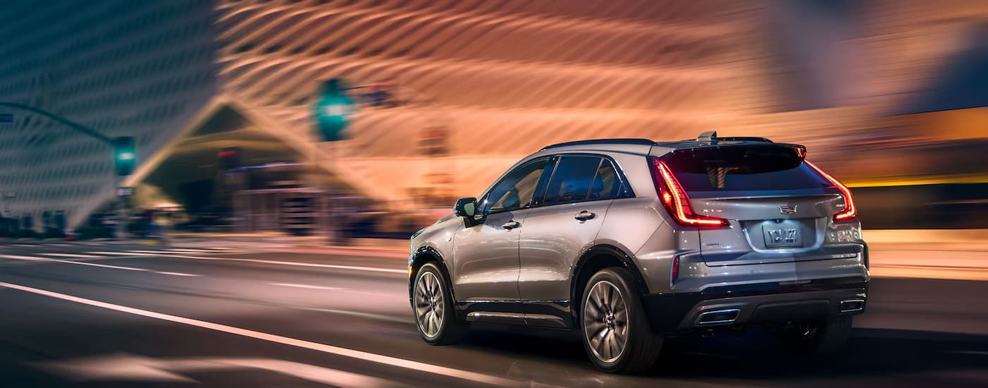 A silver 2025 Cadillac XT4 driving in a city