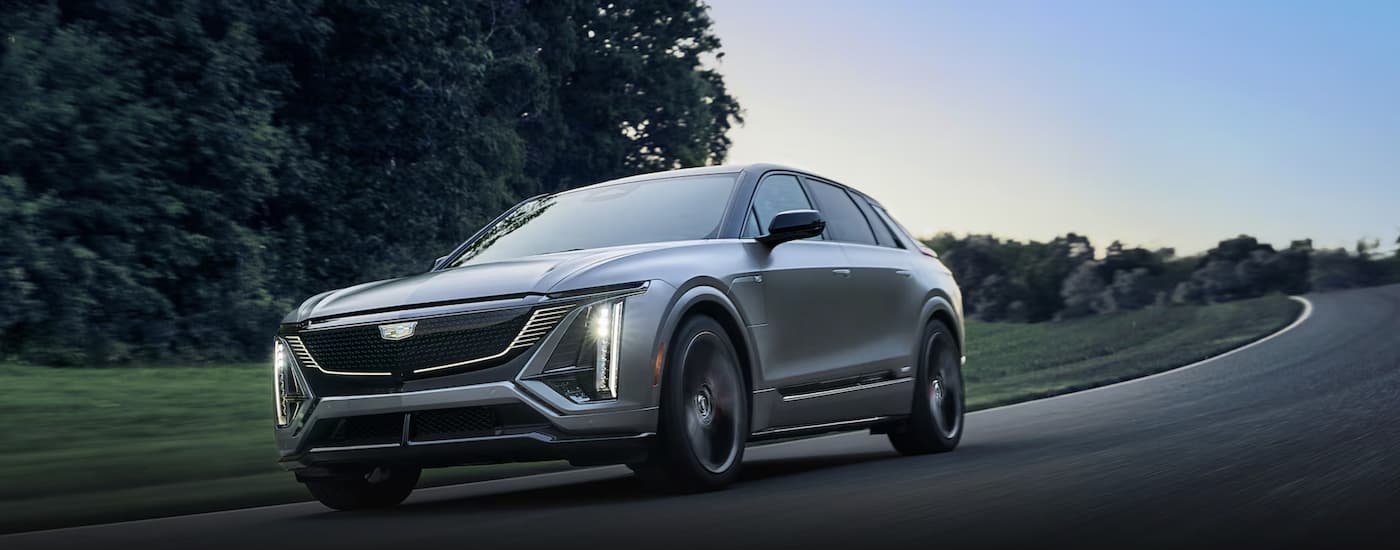 A silver 2026 Cadillac LYRIQ-V driving down a road